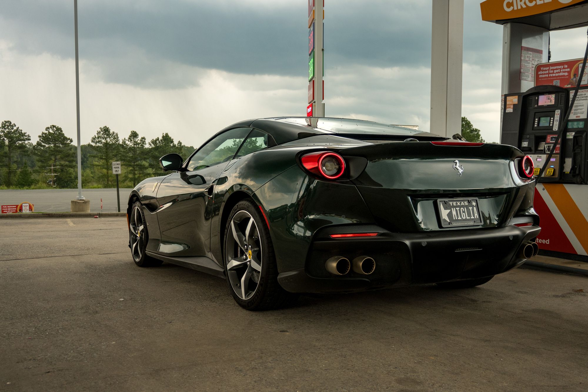 The Portofino sits, getting fuel. Dramatic reflections show the curves and angles of the vehicle.